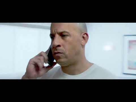 Furious 7 official trailer frame with the crew lined up by the cars, signaling a high-octane, globe-hopping mixtape