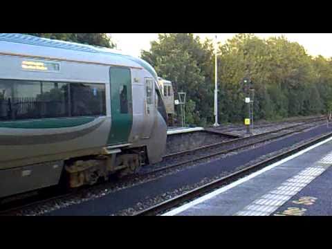 Irish Rail DMU departing Athlone with the Timder Train in the background