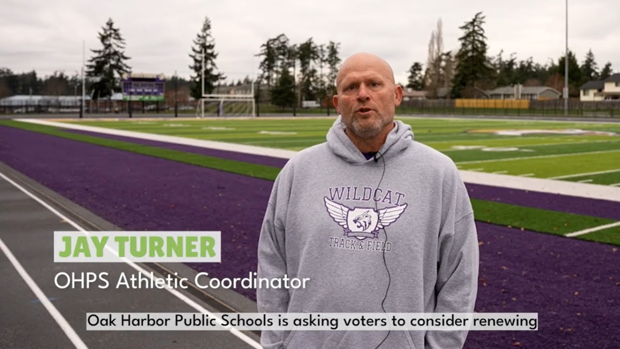 Video preview image of Jay Turner, OHPS Athletic Coordinator, stands on a purple track that surrounds the football field at Oak Harbor High School.; click to visit the ParentSquare post with the video