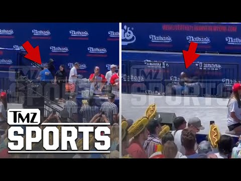 Joey Chestnut Takes Down Protestor With Headlock During Competition