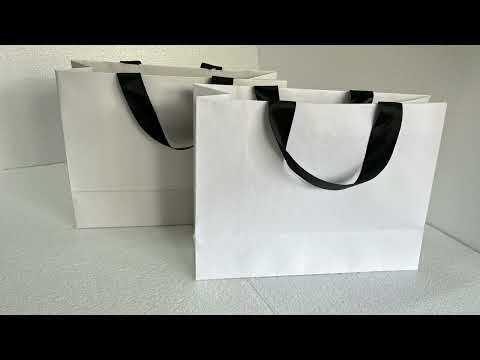 Assorted custom logo printed paper bags with embossed sticke...