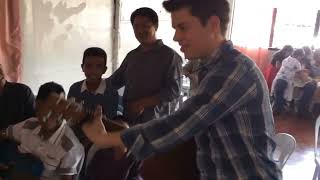 Lawson bates singing "just alittle talk with Jesus" with a group of children in tacloban