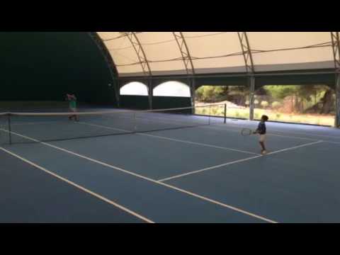 Rafael Pagonis playing tennis with dad at age 5