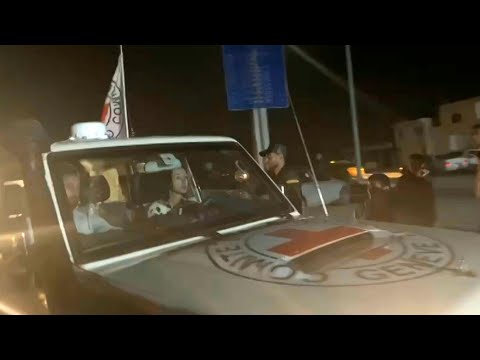 Two released hostages seen on board Red Cross convoy crossing Rafah | AFP