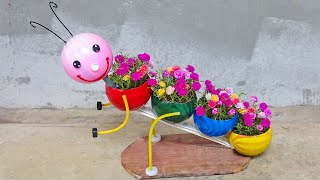 קשטו את הגינה עם עציצים מצחיקים בצורת כדורי פלסטיק ממוחזרים