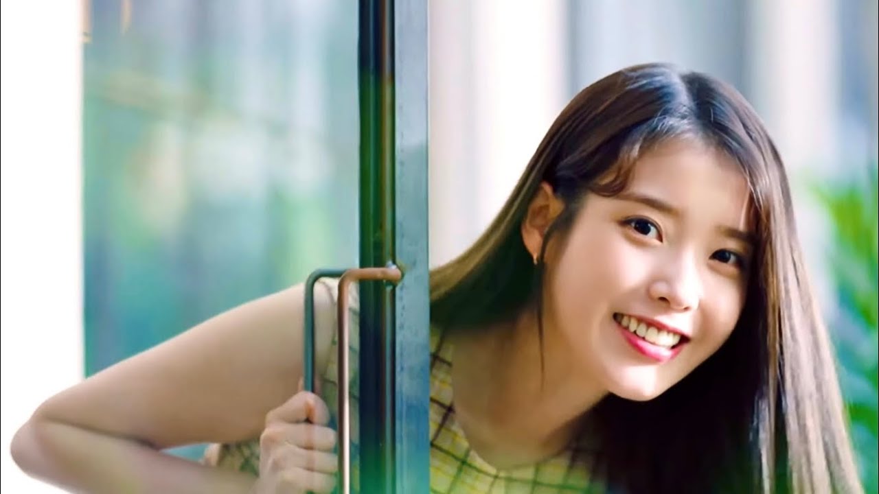 IU holding a Binggrae banana flavored milk bottle in a Korean commercial showing the iconic round packaging