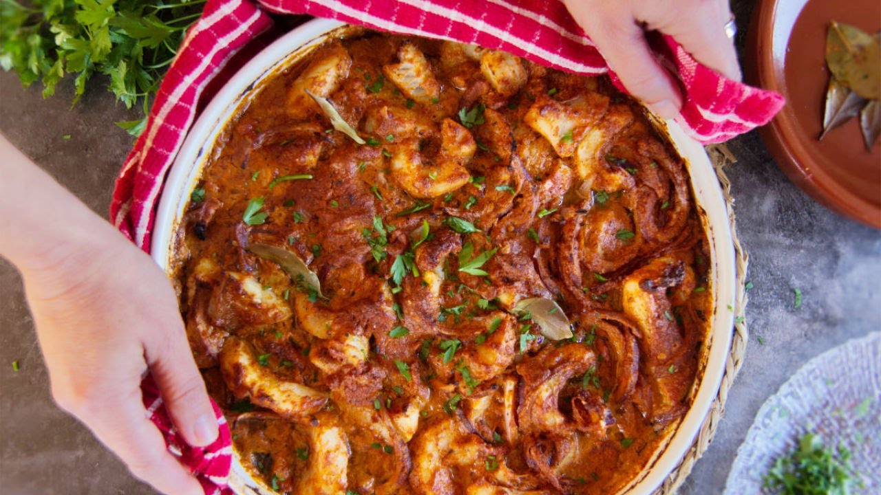 a large pot of Catalan Romesco fish stew with some parsley garnish