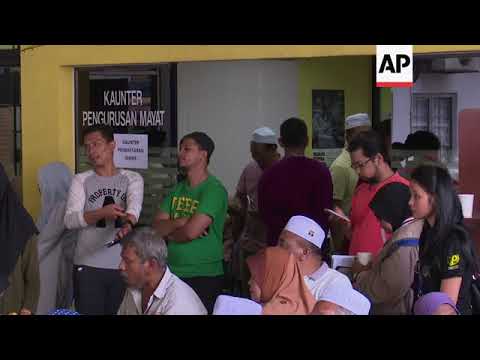 Families of Malaysia fire victims gather at morgue