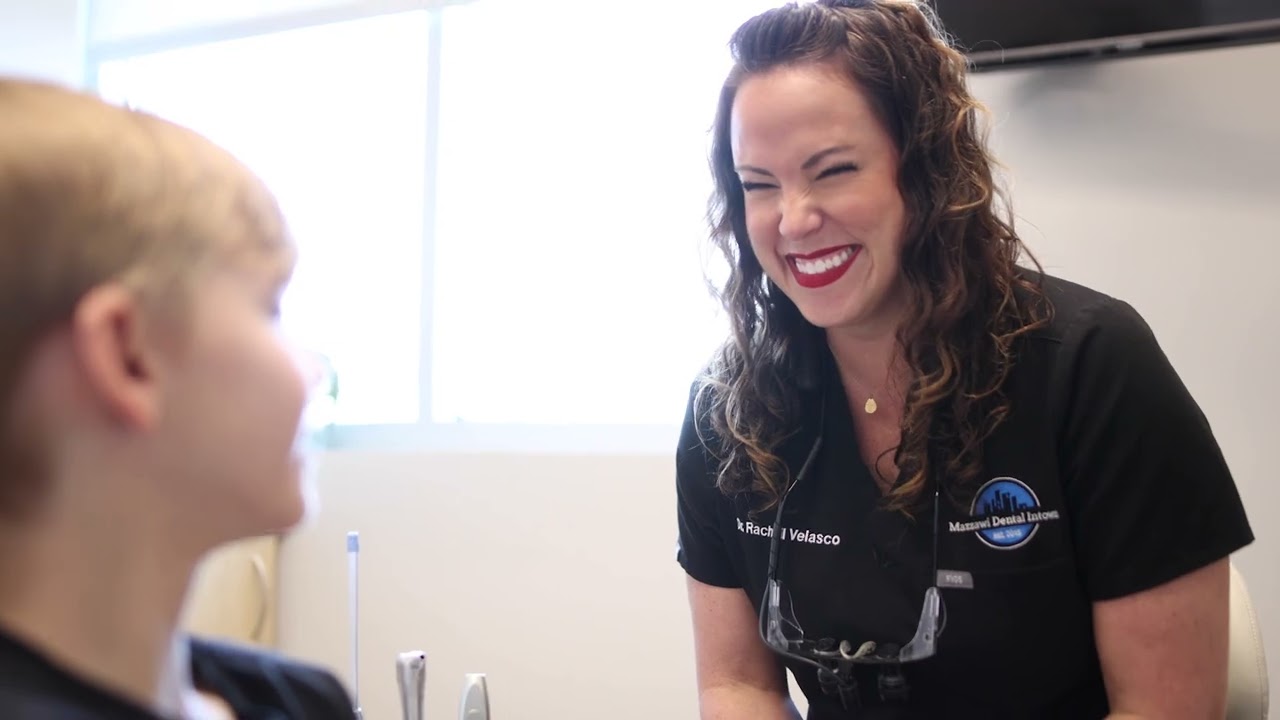 Doctor Velasco laughing while talking with a patient