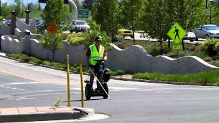 A blind man rides his Segway in traffic in Boulder, Colorado
