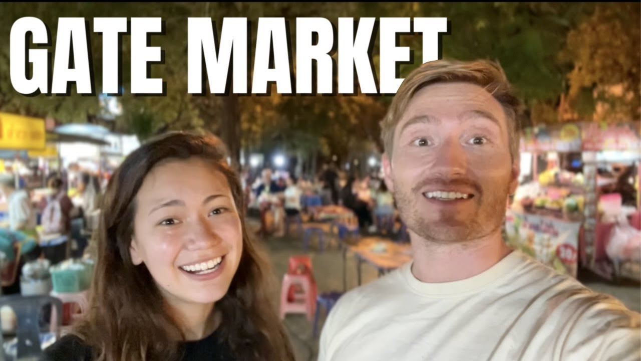 Two adventurers savor exotic flavors while exploring Chiang Mai Gate Night Market.
