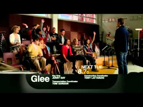 Regionals-era promo frame with New Directions onstage under bright wash lights