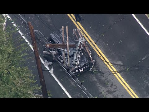 Utility pole falls onto Acton, Massachusetts vehicle on street