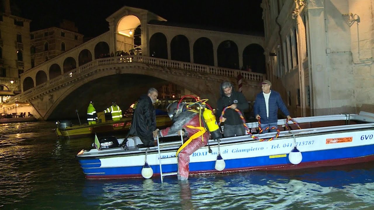 Venice gondoliers dive into murky canals for nocturnal clean-up | AFP