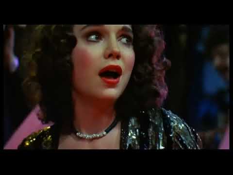 Trailer collage: Juicy Fruits doo-wop spoof; Phoenix in spotlight; glam stage rig before Beef’s fatal lightning strike