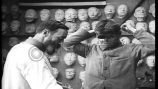 Red Cross worker contrasts the face of a wounded soldier with and without a compl...HD Stock Footage