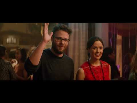 Zac Efron and Chloe Grace Moretz facing off in a party-lit scene from Neighbors 2 trailer