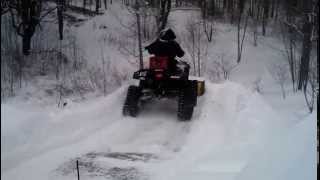 preview picture of video 'ATV with tracks plowing onto huge snow ramp'