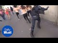 Police Officer Distracted By Topless Femen Protest Runs Into Wall Daily Mail
