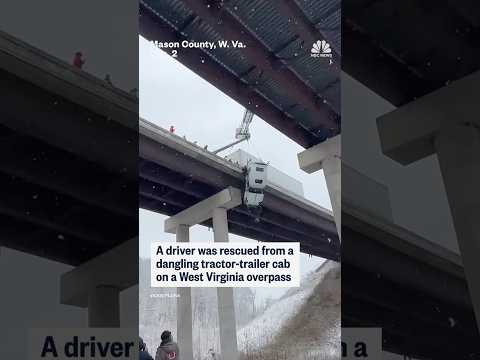 A driver was rescued from dangling tractor-trailer cab on a West Virginia overpass