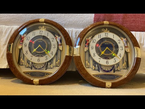 Both Generations Of QXM128BRH - Seiko Melodies In Motion Wall Clock
