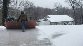 Hack for shoveling snow off driveway with sheet of plywood.