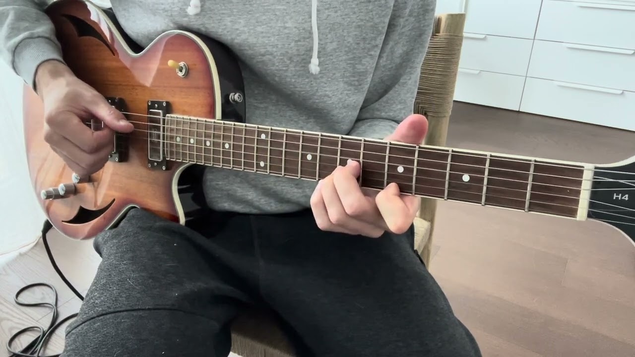 Guitarist playing the Bitter Sweet Symphony string riff by The Verve on electric guitar
