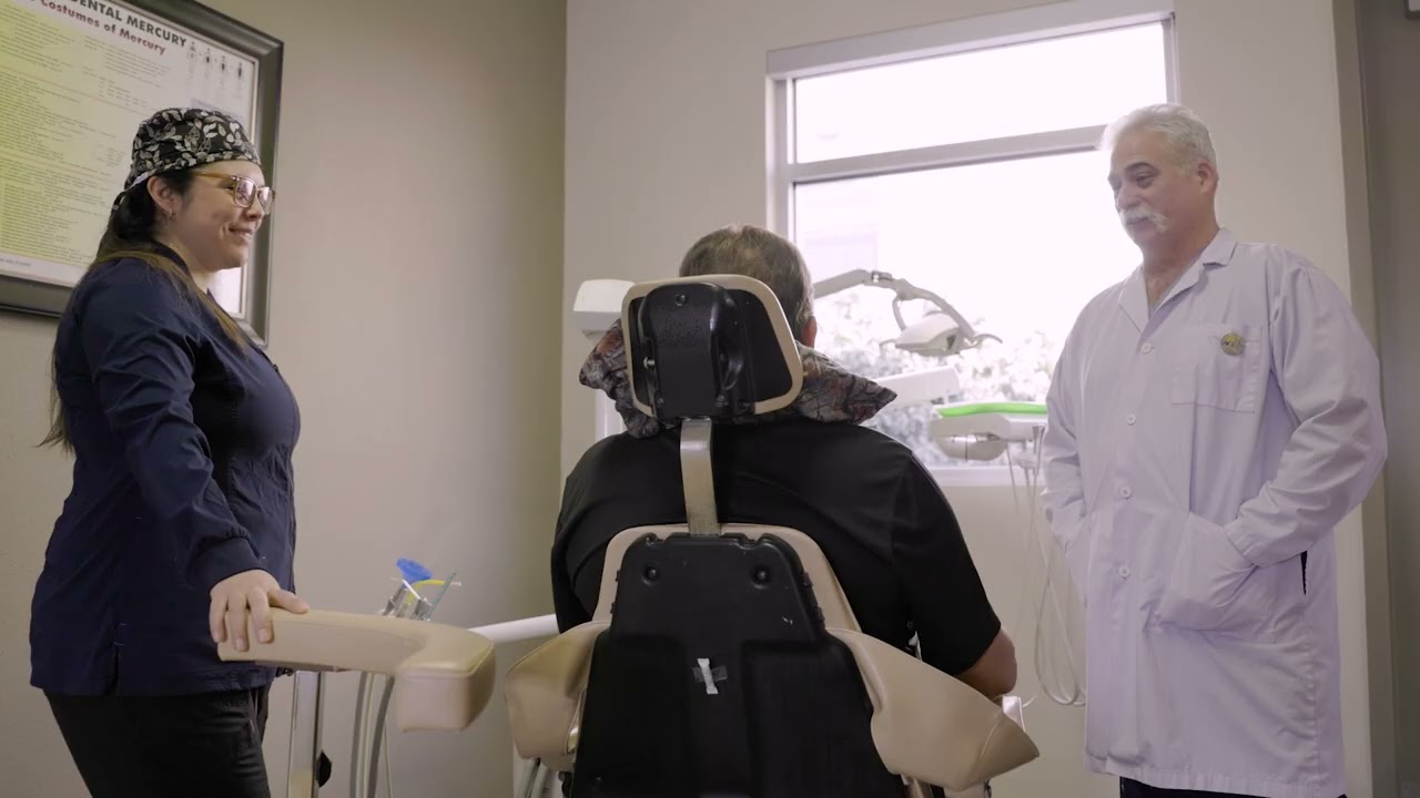 Albuquerque dentist and assistant talking to patient in dental chair