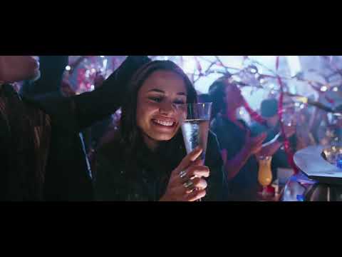 Trailer frame — exterior shot of the overturned liner; end-credits ballad begins after the final rescue image