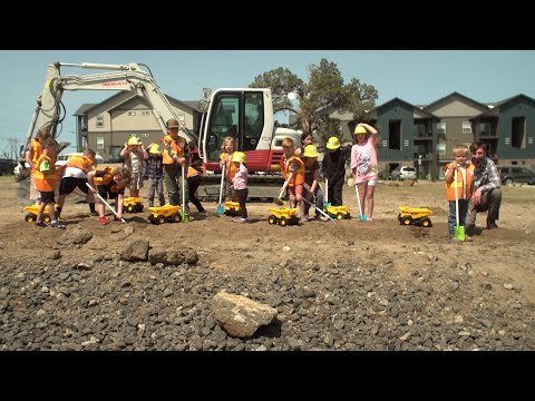 Kids break ground on new playground for unhoused families