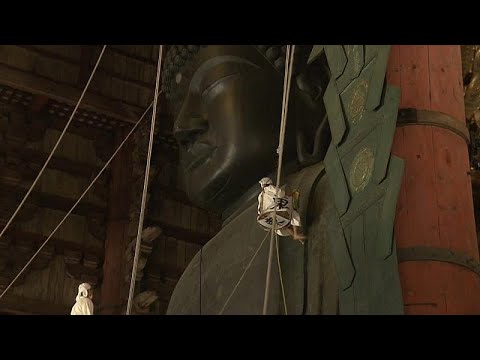 Watch: Worshippers dust the statue of Buddha ahead of festival