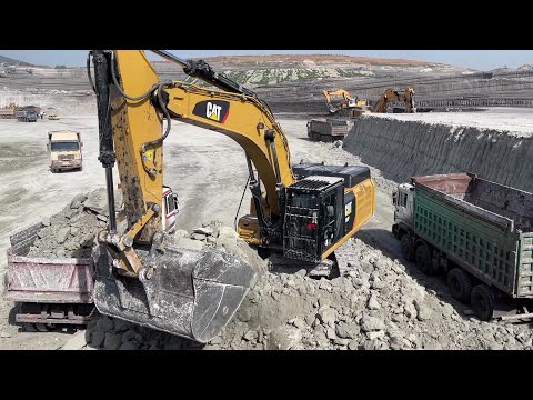 Caterpillar 352F Excavator Loading Mercedes And MAN Trucks On Huge Mining Site