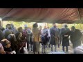 Family singing at Momo’s Graveside  “Sit Down Servant”