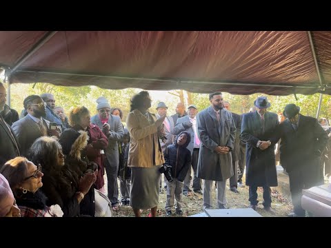 Family singing at Momo’s Graveside  “Sit Down Servant”
