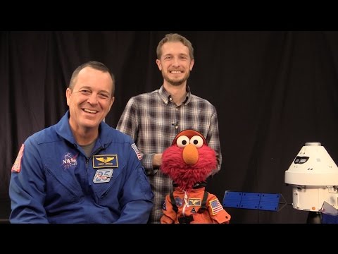 Jason Davis talks with Elmo and astronaut Ricky Arnold