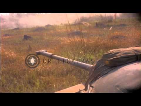 M-48 tanks moving through a field and fire machine guns during armored vehicle ev...HD Stock Footage