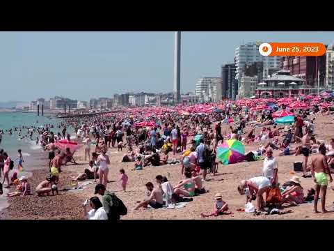 British city dwellers hit the beach to cool off