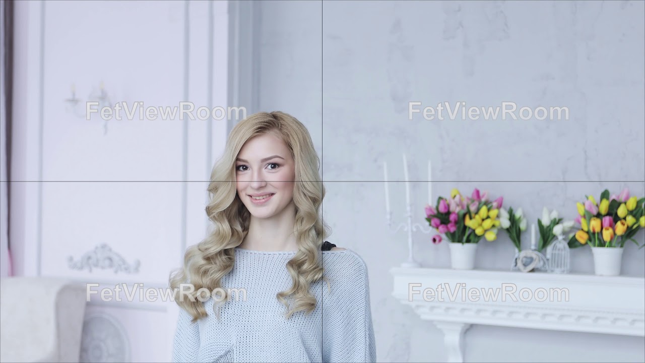 Portrait of young beautiful woman with curly blonde hair.