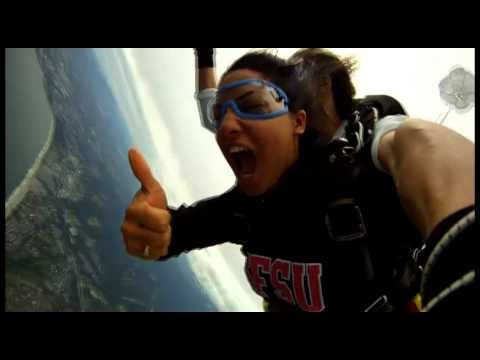 Khadija Skydives onto the beach with happiness at skydive surfcity
