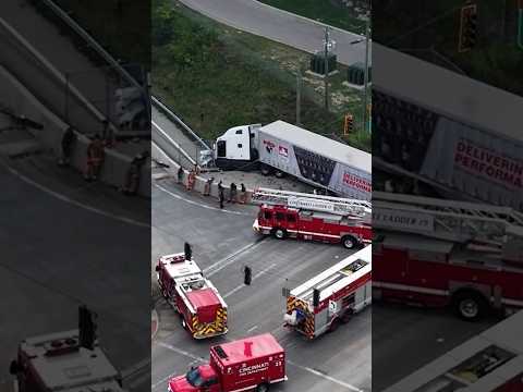 Semi-truck crashed into overpass wall, left dangling