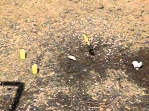 .22 bullets hitting soft drink cans in slow motion - visible bullets