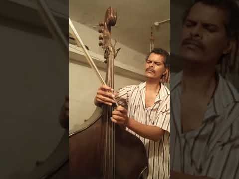 Roque  Lazarus trying out a home made double bass