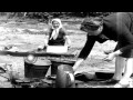 Russian women iron clothes and cook food at ...