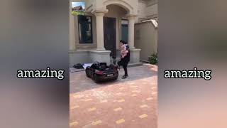 Adorable boy with expensive car toys.