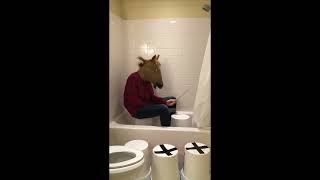 Man-horse plays &quot;Africa&quot; by Toto on a bucket in a shower
