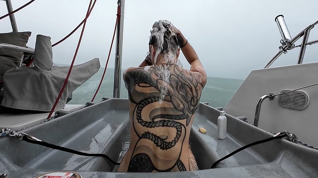 ICE COLD BATH IN THE RAIN (new use of our recycled dinghy)