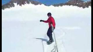 Snowdecking in soft snow behind skidoo