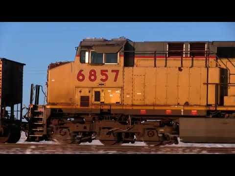 UP coal train climbs grade and passes wood water tower Lusk, Wyoming