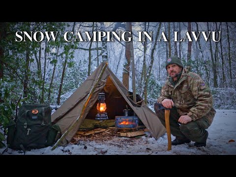freezing cold uk wild camp - polish lavvu in a snow covered uk woodland