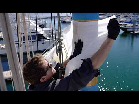 Laying up fibreglass in the rig, while hanging from the mast...